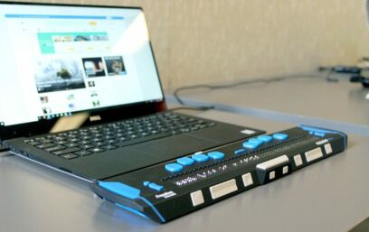 Keyboard for blind people in front of a laptop
