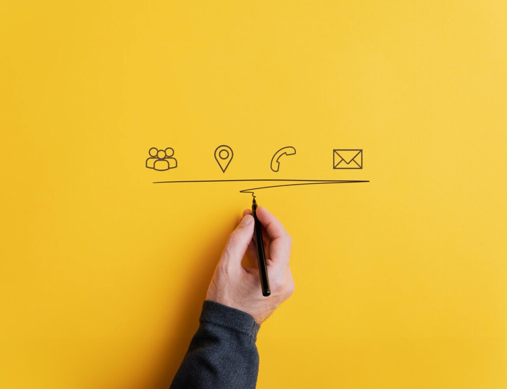 Hand drawing communication symbols on a yellow background.